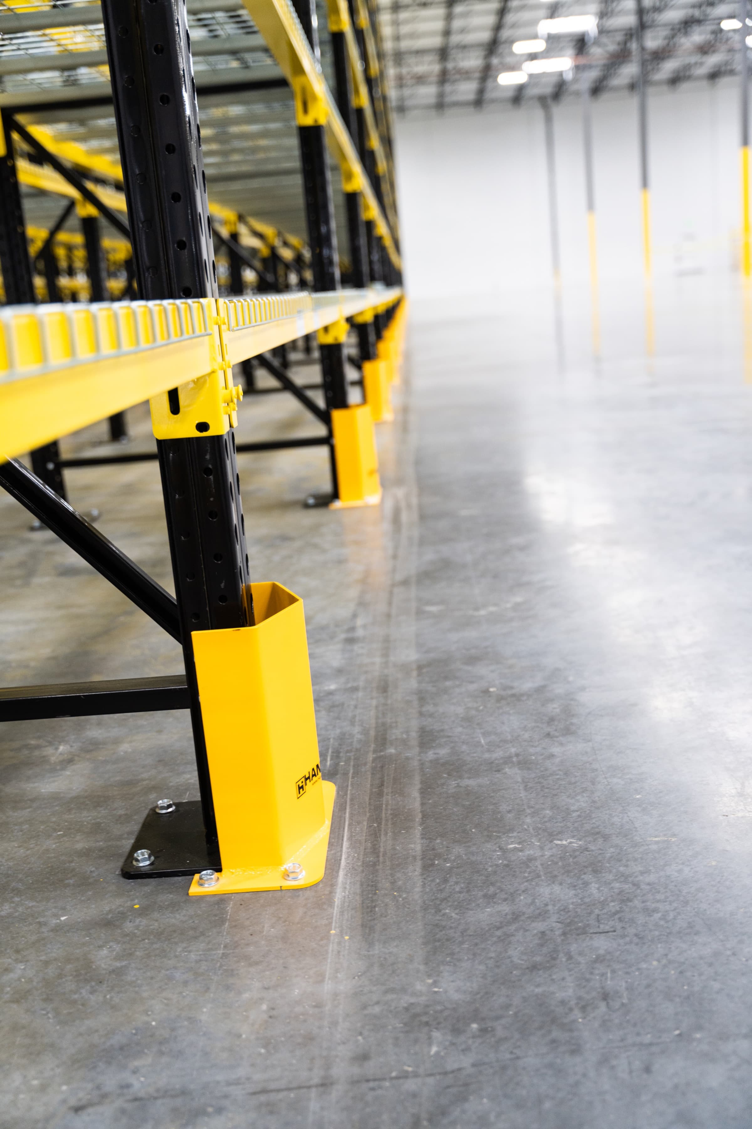 Close-up of pallet rack base plate and anchor bolts